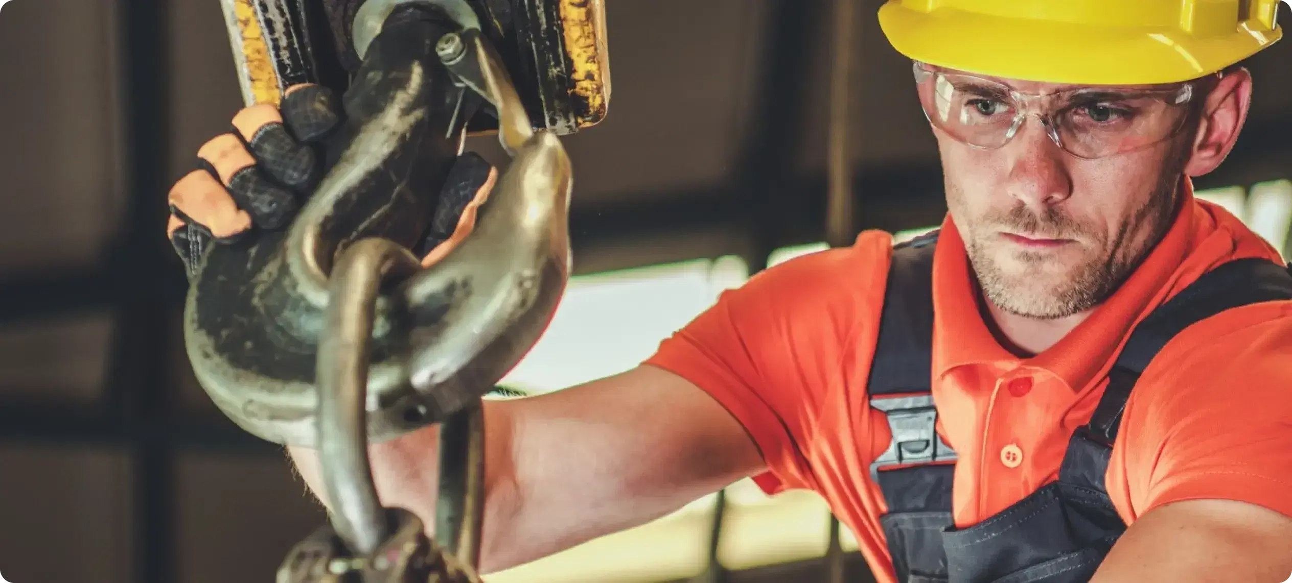 worker inspecting lifting equipment